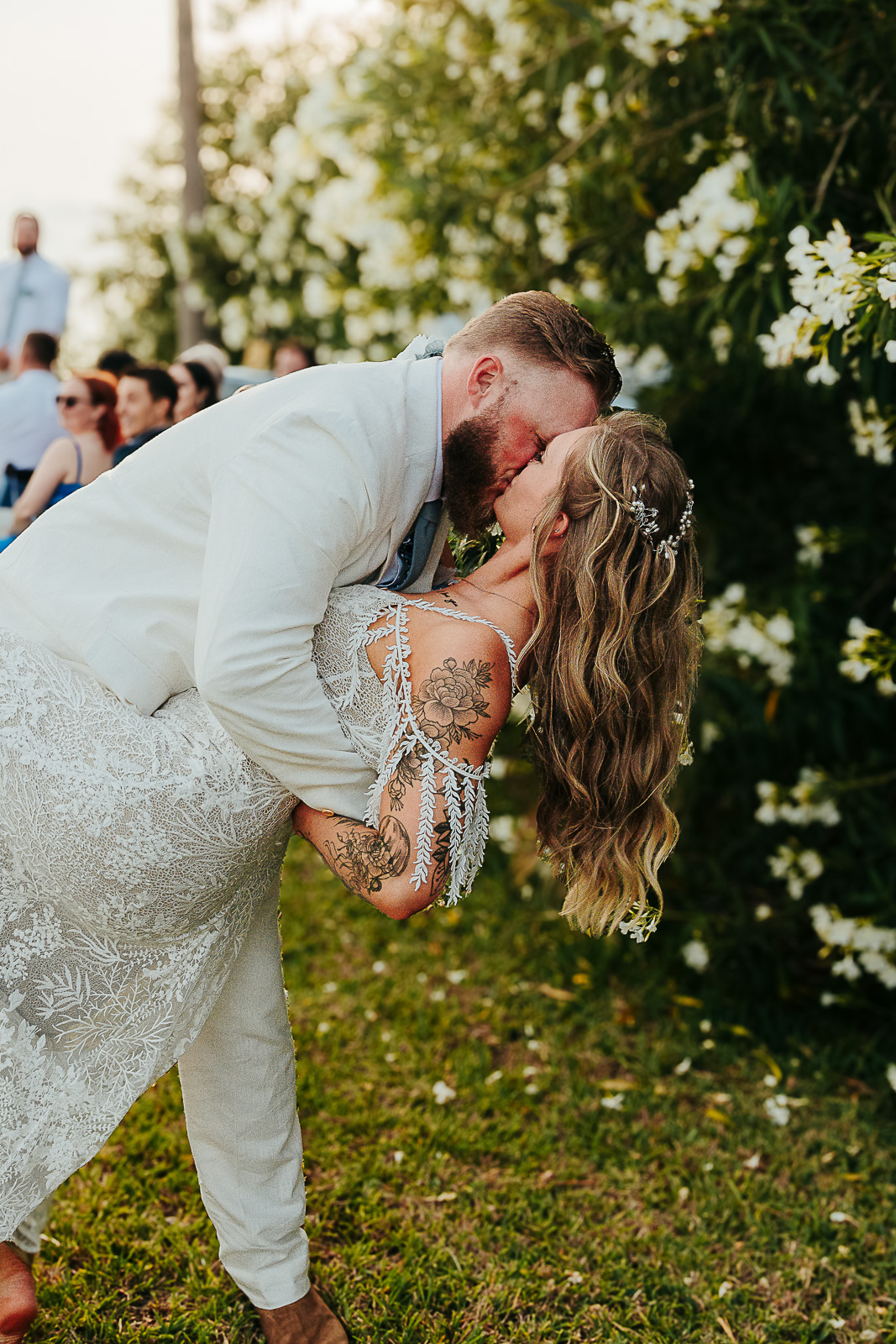 Bride and groom embracing on a weathered dock at golden hour, Texas Hill Country wedding by Weddings by Wendi