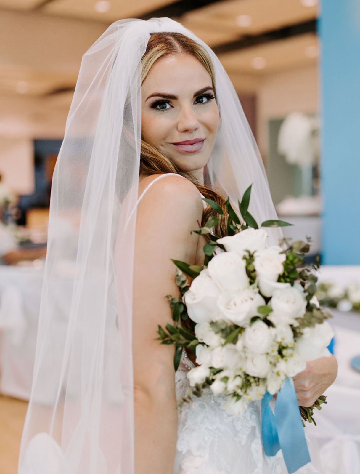 Bride in veil holding white rose bouquet with blue ribbon, bridal portrait by Weddings by Wendi