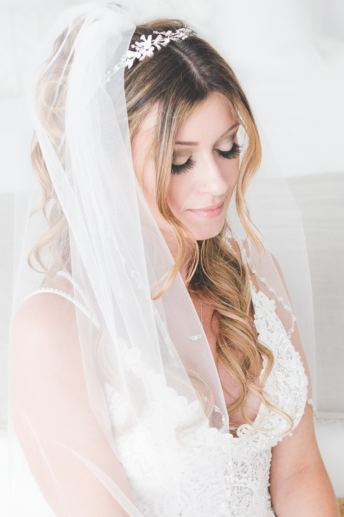 Bride portrait with delicate white veil and lace gown details, wedding photography by Weddings by Wendi