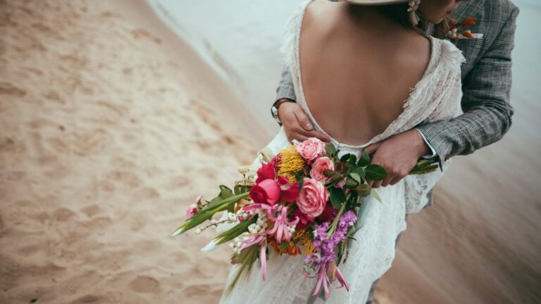 a woman in a wedding dress holding a bouquet of flowers