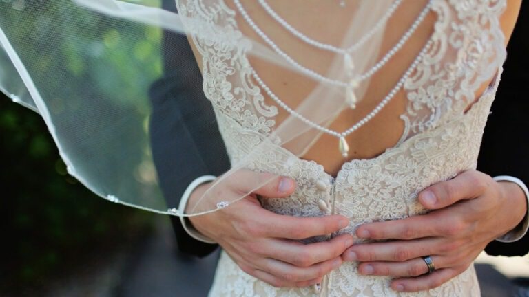 a bride and groom holding hands together