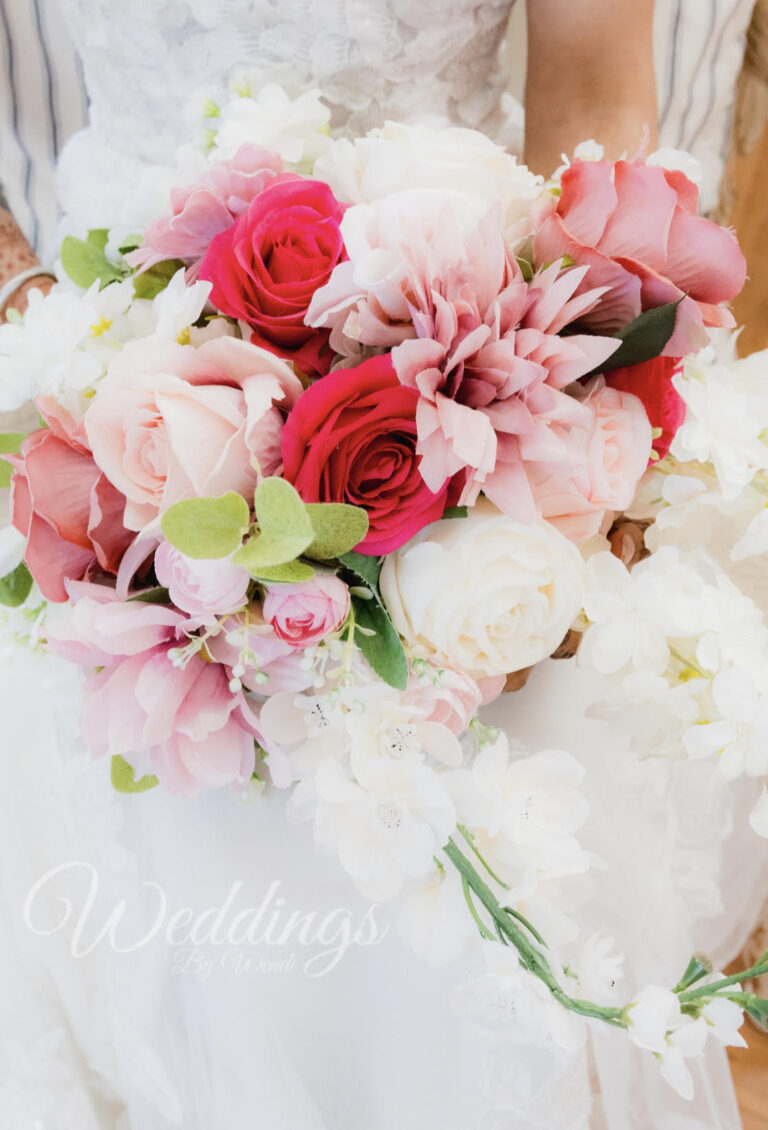 a bouquet of flowers in a person's hand