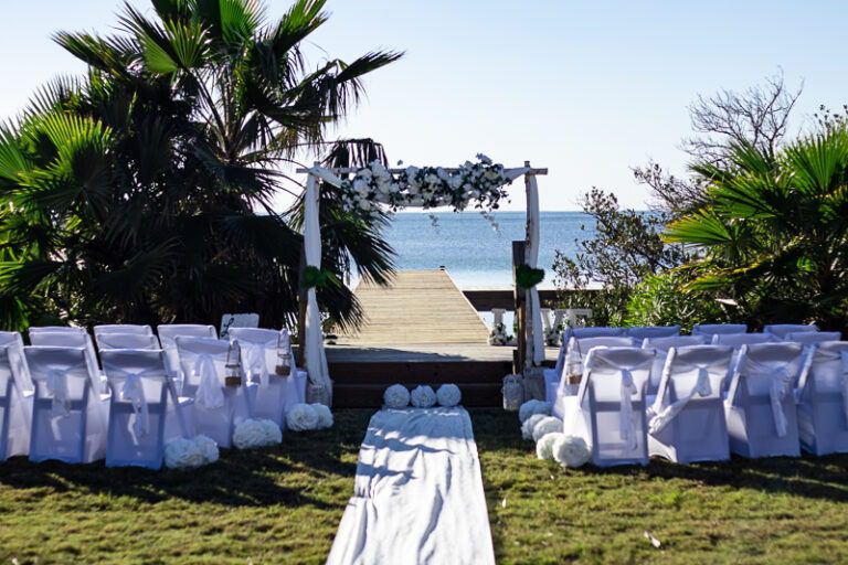 an outdoor wedding setup with white linens and flowers