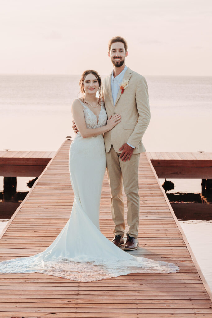 Full Wedding Planning - Weddings By Wendi a man and woman posing for a picture on a dock