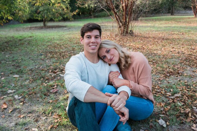 a man and woman are sitting on the ground