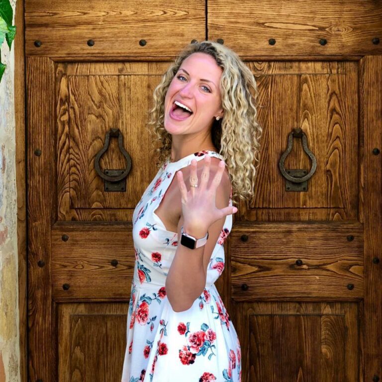 a woman standing in front of a wooden door