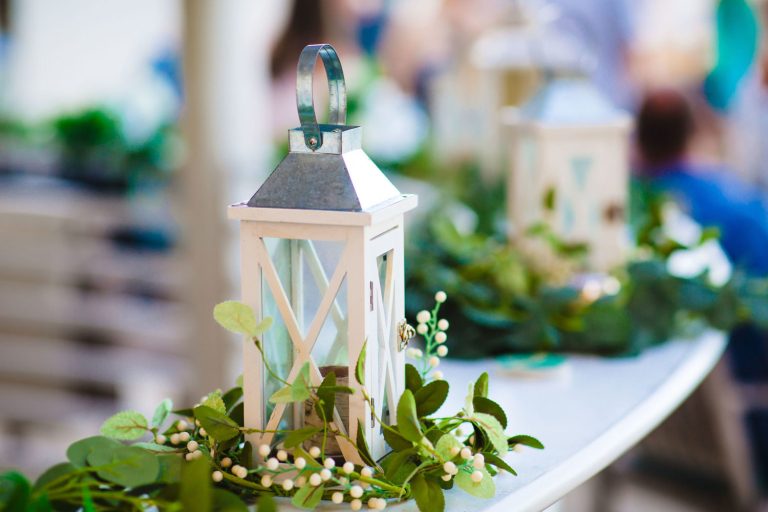 a white lantern is sitting on a table