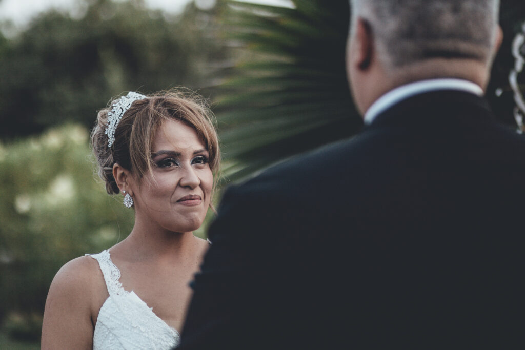 a woman in a wedding dress standing next to a man