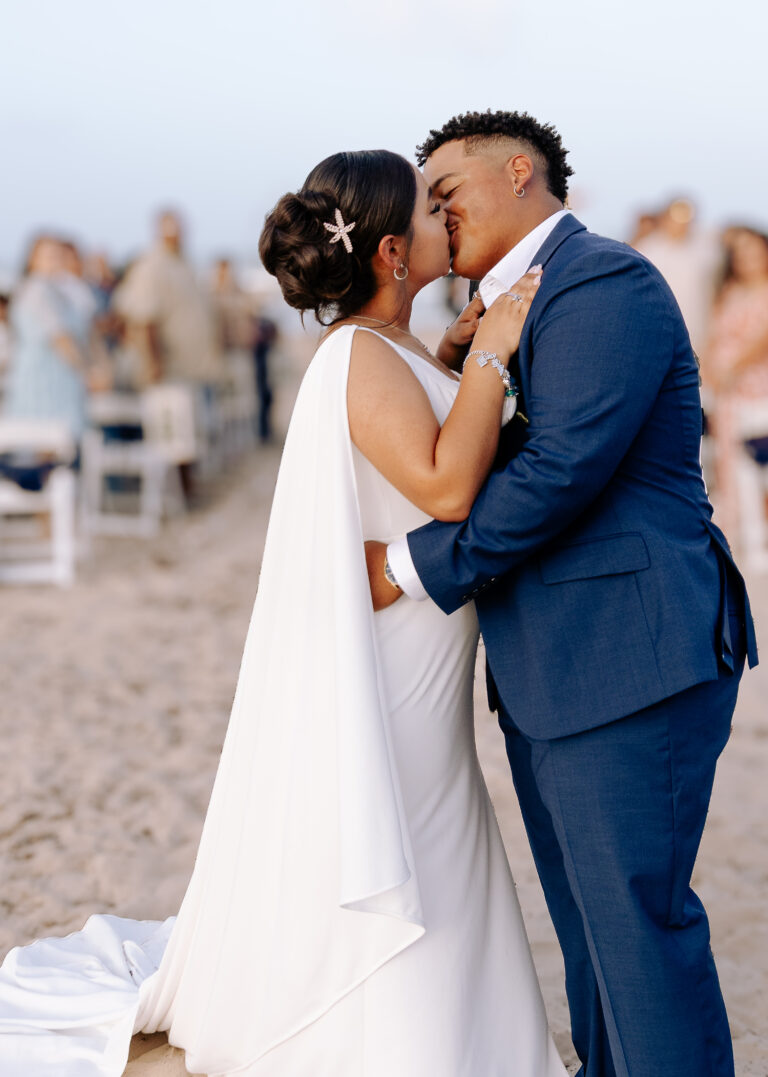 Full Wedding Planning - Weddings By Wendi a man and woman kissing on the beach