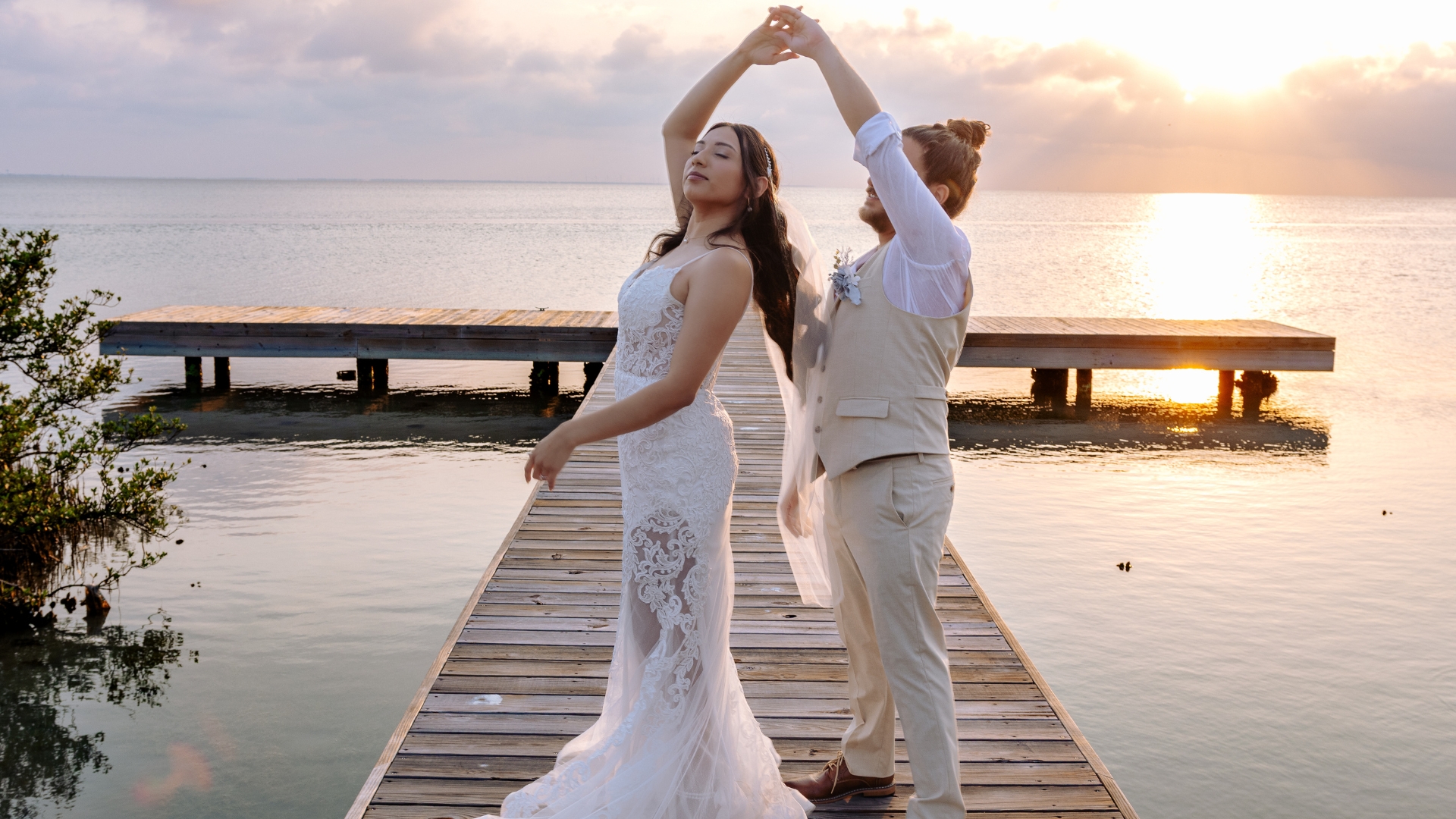 Full Wedding Planning - Weddings By Wendi a man and woman posing for a picture on a dock
