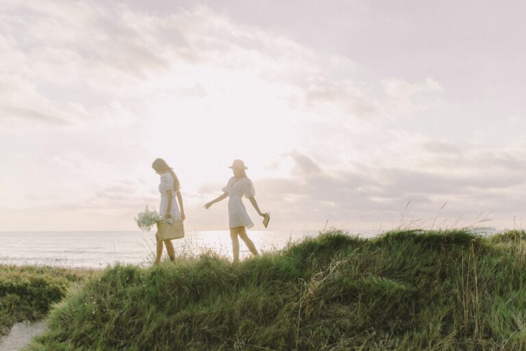 women walking on beach during a boho wedding