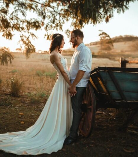 a man and woman standing next to a cart