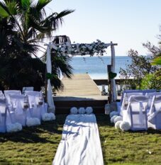an outdoor wedding setup with white linens and flowers