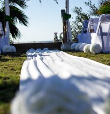 a wedding setup with white linens and flowers