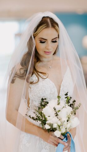 a woman in a wedding dress holding a bouquet