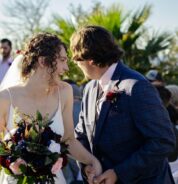 a bride and groom standing next to each other