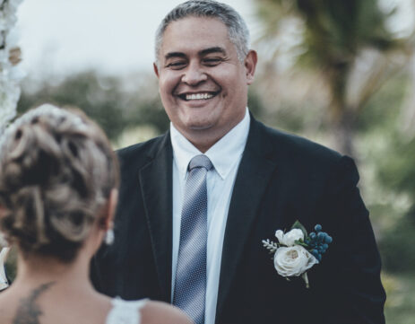 a man in a suit and tie standing next to a woman