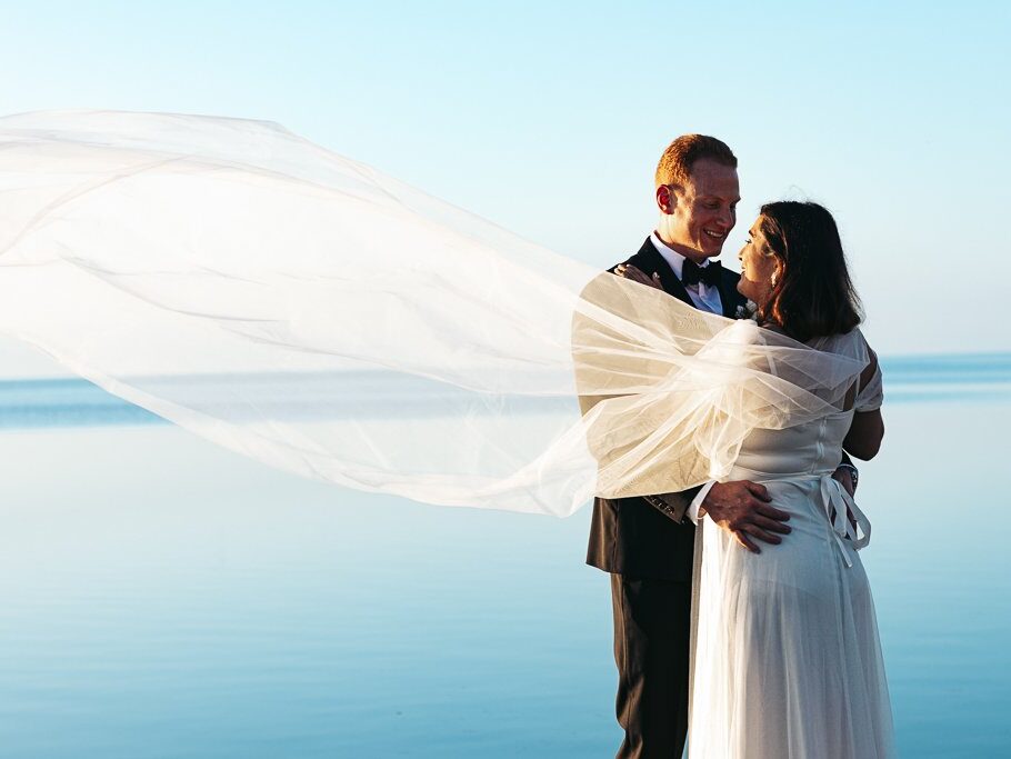 a bride and groom standing next to each other