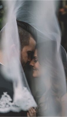 a bride and groom are looking at each other