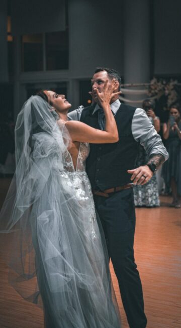 a bride and groom dance together on the dance floor