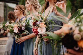 a group of women holding flowers