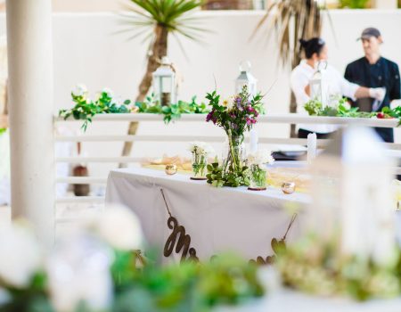 a table with flowers and greenery on it
