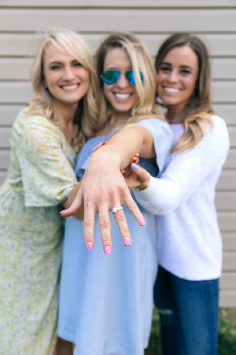 three women are posing for the camera with their hands in the air