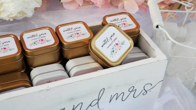 four small tins of wedding favors in a wooden box