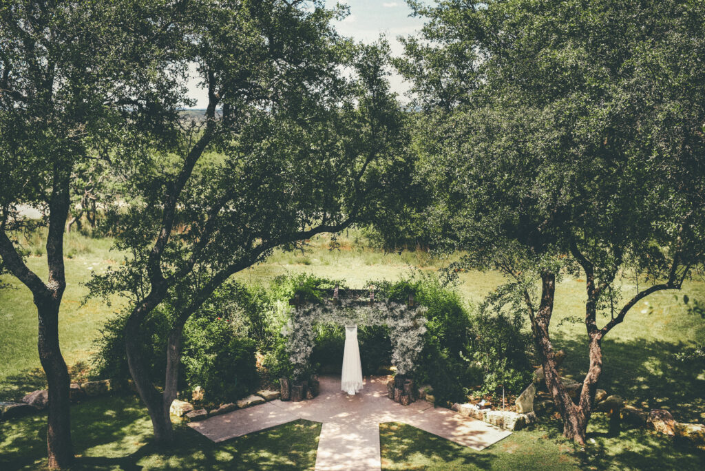 Full Wedding Planning - Weddings By Wendi a wedding dress under a arch