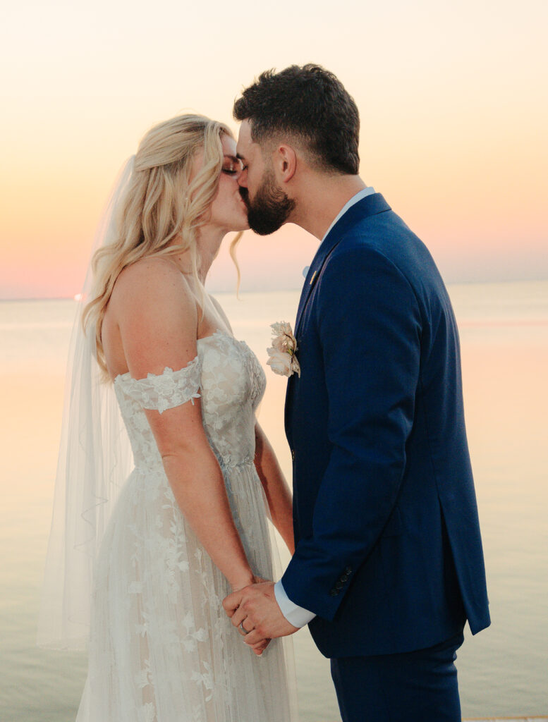 Full Wedding Planning - Weddings By Wendi a man and woman kissing on a beach